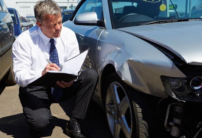 car insurance policy documents and a smartphone